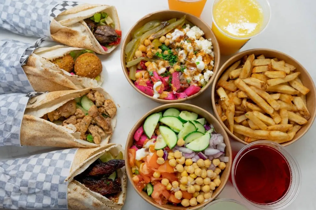 Chickpz catering spread with bowls, wraps, and sides